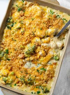 a casserole dish with broccoli, cheese and bread crumbs