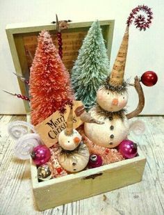 a wooden box filled with christmas decorations