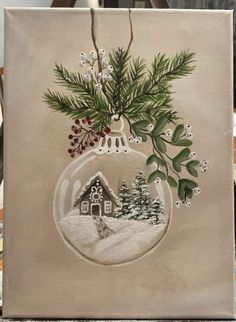 a christmas ornament is hanging on a canvas