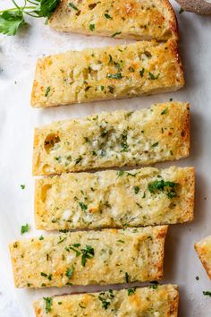 slices of garlic bread with herbs on top