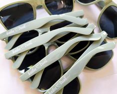 several pairs of sunglasses are sitting on a table with the words made in white printed on them