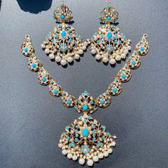 Design inspiration from the Edwardian Era. This gorgeous necklace set has been made in 22ct hallmarked gold and set with pearls and turquoises. Gross Weight - 48 GMs Price Breakup Summary Component Rupees % of Total 22k Gold 233,836 76.9% Stones & Beads 19,298 6.3% Making Charges 42,090 13.8% Taxes (GST) 8,857 2.9% Total 304,081 100.0% View Detailed Price Breakup Exquisite Turquoise Jewelry As Gift, Exquisite Turquoise Jewelry For Gift, Exquisite Turquoise Jewelry Gift, Ceremonial Blue Meenakari Jewelry, Traditional Turquoise Jewelry Sets As Gift, Traditional Turquoise Jewelry Set For Gift, Turquoise Kundan Chandbali Jewelry, Elegant Turquoise Kundan Necklace For Festive Occasions, Traditional Turquoise Jewelry Hand Set