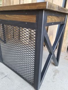 a wooden table with metal mesh on top