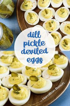 deviled eggs with dill pickle deviled eggs in the middle on a plate