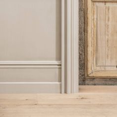 a cat sitting on the floor in front of a door