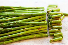 the asparagus are ready to be cut into small pieces on the cutting board