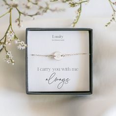 a personalized bracelet in a gift box with the words, i carry you with me as always