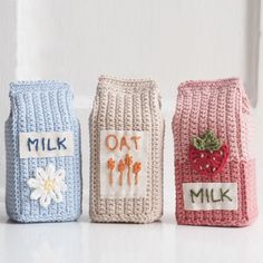 three crocheted milk bags with the words milk, oat and milk written on them