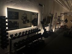 there is a gym with mirrors and lights on the wall in front of it, along with other exercise equipment