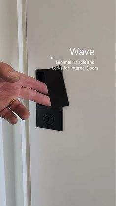 a person's hand is pressing the button on a door