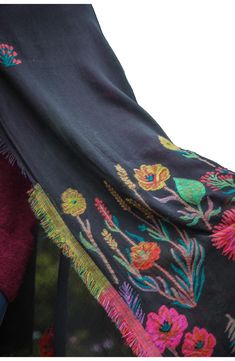 Love to layer in this eclectic lightweight scarf styled in a colorful floral pattern with fringe that is signature to Saachi's artisanal inspired brand. 39" x 75" 100% cotton Hand wash cold, line dry Imported Bohemian Cotton Scarves With Floral Print, Bohemian Cotton Scarf With Floral Print, Black Bohemian Shawl For Spring, Bohemian Pashmina Scarves With Floral Embroidery, Spring Bohemian Pashmina Scarves, Bohemian Pashmina Scarves For Spring, Traditional Cotton Shawl For Spring, Bohemian Scarves With Multicolor Embroidery, Embroidered Bohemian Scarves For Spring