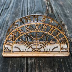 an intricately designed wooden clock sitting on top of a table