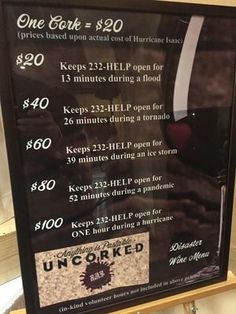 a menu for a wine tasting event is displayed in a store display case with price tags