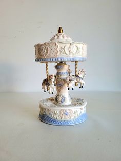 a white and blue carousel sitting on top of a table