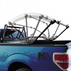 a blue pick up truck with an atv rack in the back