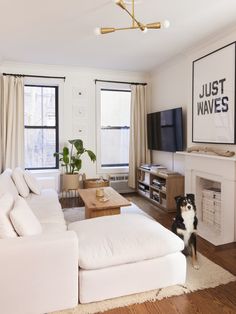 a living room filled with furniture and a flat screen tv mounted to the side of a wall