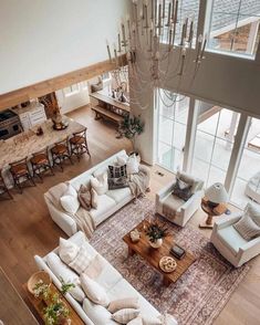 an aerial view of a living room with couches, tables and chandelier