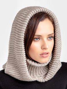 a woman wearing a gray knitted hood