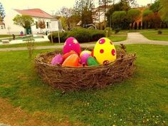 an easter basket with painted eggs in the grass