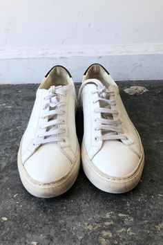 Woman by Common Projects Sneakers. White lace-up sneaker with black back panel. Size Womens 36. Made in Italy. Approx. Measurements Heel to Toe: 10" Width: 4" Classic White Lace-up Platform Sneakers, Classic Sneakers With White Sole And Laces, Leather Platform Sneakers With White Laces For Streetwear, Classic Low-top Custom Sneakers For Light Sports, White Leather Platform Sneakers With White Laces, Custom Leather Low-top Sneakers With White Laces, Sporty Leather Platform Sneakers With White Laces, Classic Lace-up Sneakers With Vulcanized Sole, Classic Lace-up Custom Sneakers With Vulcanized Sole