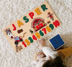 a child playing with a wooden toy on the floor