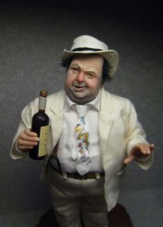 a statue of a man holding a wine bottle