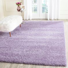 a purple rug with a bench in front of it