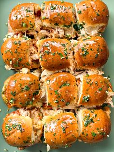 a platter filled with rolls covered in meat and cheese