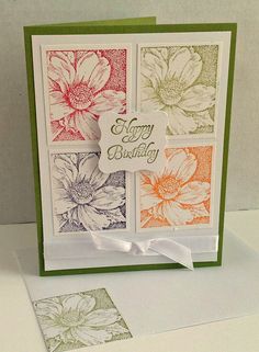 a card with flowers on it and the words happy birthday written in green, orange, and white