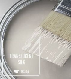 a paint brush is being used to paint a wall with translucent white paint on it