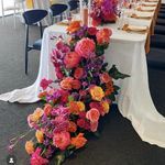 the table is set up with flowers and place settings for an event or special occasion