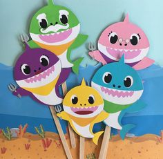 there are some cute little sharks on sticks