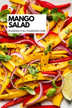 mango salad with red onions, peppers, and lime on a white plate topped with cilantro