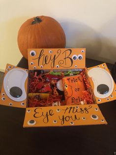 an orange box filled with candy and halloween decorations