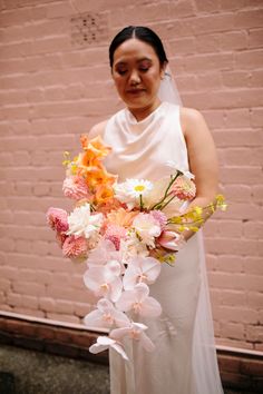 a woman in a white dress holding a bouquet of flowers