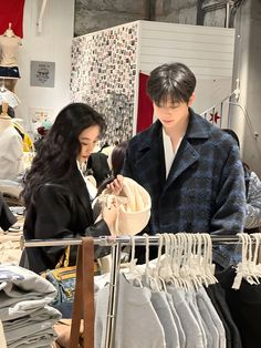 two people looking at clothing in a store