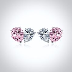 two heart shaped pink and white diamond earrings