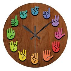 a wooden clock with colorful hand prints on it