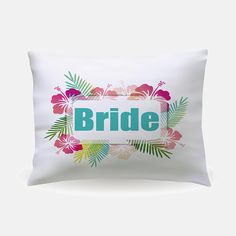 a white pillow with the word bride printed on it and tropical flowers surrounding it,