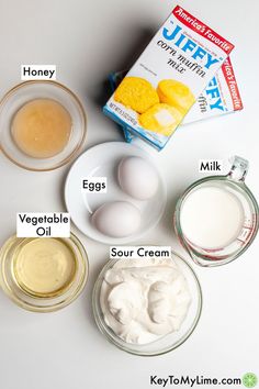 ingredients to make an egg muffin recipe on a white counter top, including eggs, sour cream and yogurt