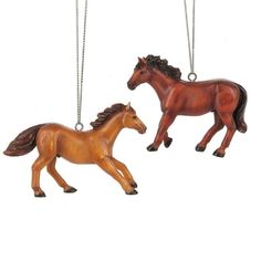 two wooden horses hanging from chains on a white background