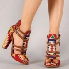 a woman's legs wearing high heels with colorful designs on the heel and straps