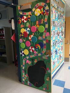 an art display in the middle of a school hallway with balloons and pictures on it