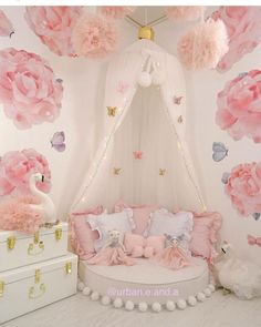 a room decorated with pink flowers and white furniture