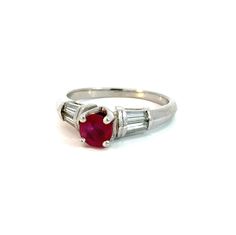 Vintage ruby and diamond ring set in platinum.  This lovely ring showcases an round 0.72ct ruby flanked by four baguette cut side diamonds totaling 0.26ctw.  The classic, contemporary design holds the ruby high and features a knife edge band for added interest.  This ring is in very good vintage condition and ready for wear. The Details: Ring size - size 6.0, sizeable Metal type - Platinum (stamped and tested)  Ring weight - 6.2 grams total Gem type - Ruby  Gem dimensions - 5.2 mm Gem cut - Roun Classic Red Diamond Ring, Baguette Cut, Classic Red Baguette-cut Diamond Ring, Classic Red Baguette Cut Diamond Ring, Red Ruby Ring With Baguette Diamonds, Diamond Color Grade, Baguette Cut, Diamond Ring Settings, Baguette Cut Diamond, Lovely Ring