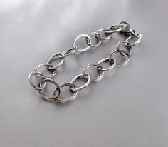 "Large link flat cable minimalist sterling silver women's bracelet. Large chunky oval links are flat, substantial, but lightweight, and bracelet is very comfortable to wear. Each link measures about ½ inch x 3/8 inch. Large teardrop lobster clasp hooks onto the end of the chain. Choose your length: 6, 6 ½, 7, 7 ½, 8, 8 ½, 9 inches. This is the actual measurement of the bracelet. Length may be as much as ¼ inch off because the super long links makes it hard to be accurate. Designed for women. Min Modern Sterling Silver Bracelet With Rolo Chain, Everyday Chunky Oval Link Bracelets, Modern Chunky Oval Link Bracelets, Womens Sterling Silver Bracelets, Sterling Silver Bracelet, Etsy Shipping, Tiffany Heart, Heart Charm Bracelet, Chain Link Bracelet