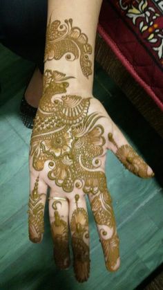 a woman's hand with henna on it