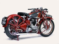 an old fashioned red motorcycle is parked on a white background with the number twenty forty