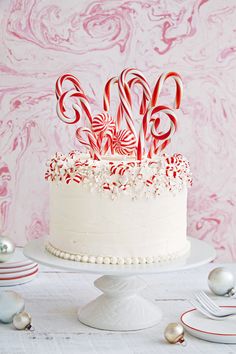 the cake is decorated with candy canes