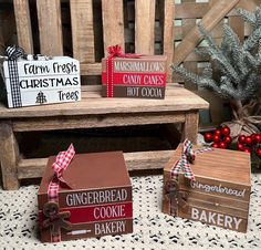 three wooden boxes sitting on top of a table next to a christmas tree and other decorations